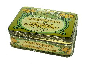 Liquorice tin in an 'art nouveau' style from about 1900. The castle ruins are shown after the Victorians have turned the site into a park. The top of the keep shows a 'window' shaped hole which was knocked through the archaeology to create a distant view of St. Giles. The weakened wall later collapsed. [Click here to open image in popup]