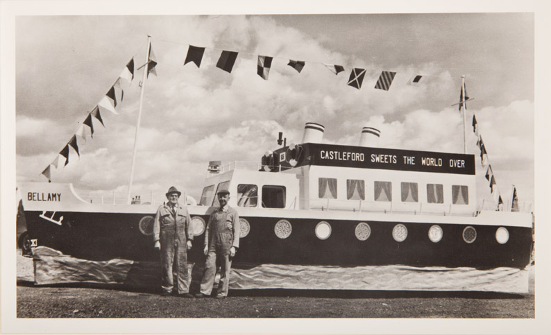 The image shows a life size model of boat painted 'Castleford Sweets The World Over' and 'Bellamy'. In 1870 Joseph Bellamy started manufacturing in Leeds, but in 1899 moved to Castleford. They became known for their mint imperials, French almonds as well as chocolate covered liquorice allsorts. In 1935 Joseph Bellamy & Sons Ltd became incorporated.The business was run in turn by the Bellamy family until it was taken over by John Mackintosh Ltd in early 1964. [Click here to open image in popup]